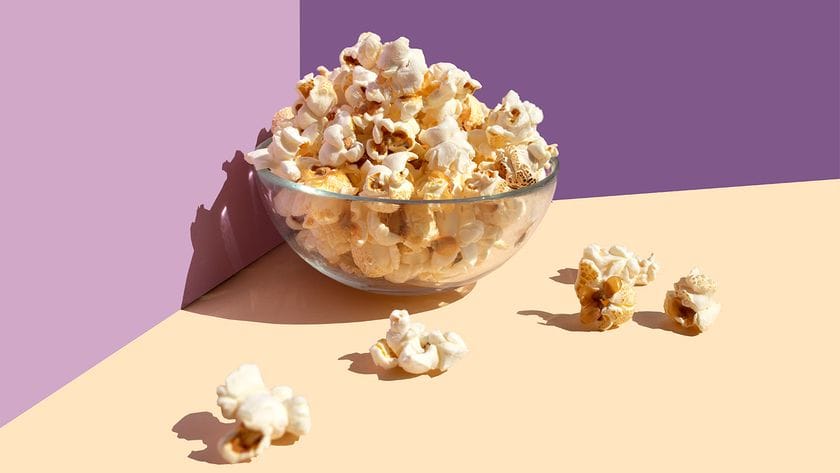 bowl of popcorn purple background abstract